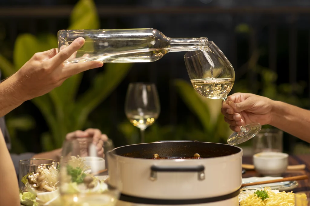 Vino blanco vertido sobre una copa.